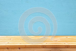 Empty table in front of blue wooden background. For product display montage