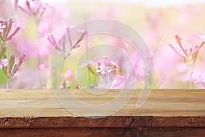 Empty table in front of spring field flowers background