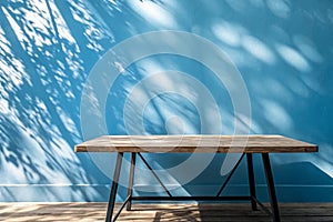 Empty table on smooth blue wall background