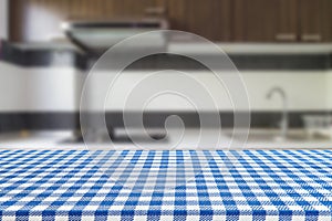 Empty table with tablecloth and blurred kitchen background, product montage display