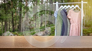 Concept for organic clothes and sustainable fashion. Hanger with dresses blurred in