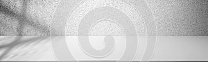 Empty table top with white concrete wall. Abstract pattern of concrete wall