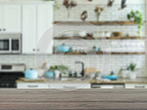 The empty table wooden board in front of the background is blurred. Brown wood perspective in the home kitchen â€“ can be used to