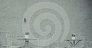Empty Tables And Chairs Against Wall