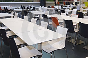 Empty tables and chairs in the fast food areea