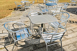 Empty tables with chairs in an outdoor cafe. Close up