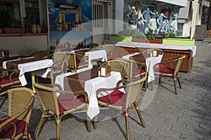 Empty tables and chairs outside of the restaurant in old city.