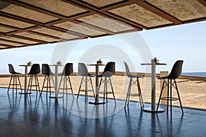 Empty tables and chairs with the seaside view