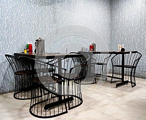 Empty Tables set for meal in modern restaurant