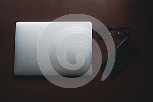 Empty tablet with smartphone and glasses on desk. Business and finance concept. Workplace, Flat lay with blank copy space