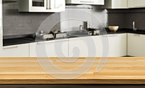 Empty tabletop over defocused kitchen with copy space