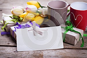 Empty tag, bright yellow and white spring tulips, boxes with gif