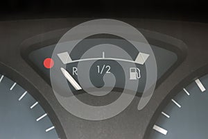Empty tank indicator on car dashboard. Concept - economic crisis