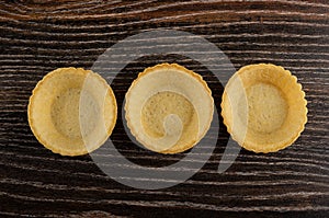 Empty tartlets on wooden table. Top view