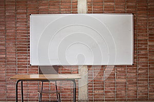 Empty Teacher`s desk in a classroom