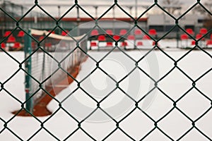 Empty Tennis Courtyard Viewed Through Wired Fence