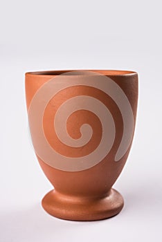 Empty terracotta mug or brown clay coffee cup or jar or drinking glass