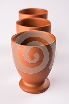 Empty terracotta mug or brown clay coffee cup or jar or drinking glass