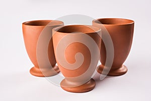 Empty terracotta mug or brown clay coffee cup or jar or drinking glass