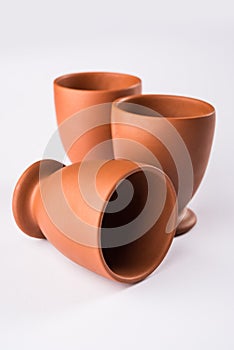 Empty terracotta mug or brown clay coffee cup or jar or drinking glass