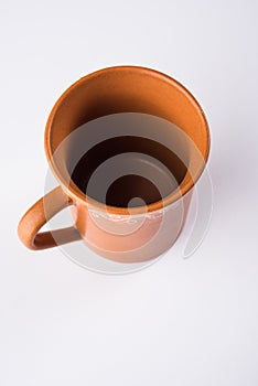 Empty terracotta mug or brown clay coffee cup or jar or drinking glass