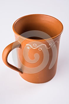 Empty terracotta mug or brown clay coffee cup or jar or drinking glass