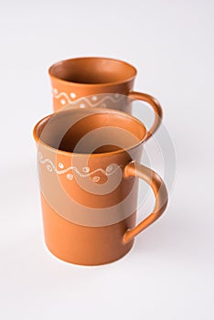 Empty terracotta mug or brown clay coffee cup or jar or drinking glass