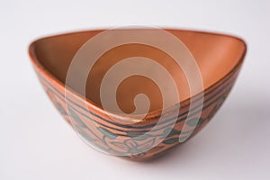 Empty terracotta serving bowl or brown clay soup bowl isolated on white