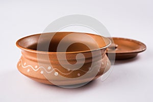 Empty terracotta serving bowl or brown clay soup bowl isolated on white