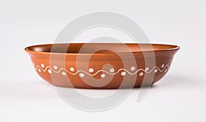 Empty terracotta serving bowl or brown clay soup bowl isolated on white