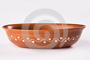 Empty terracotta serving bowl or brown clay soup bowl isolated on white