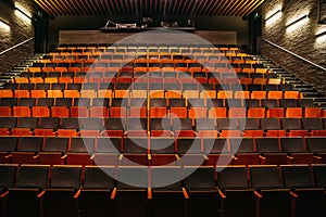 Empty theatre or cinema auditorium hall with rows of seats or chairs