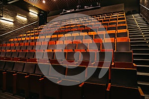 Empty theatre or cinema auditorium hall with rows of seats or chairs