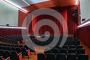 Empty theatre with red curtains stage in lights