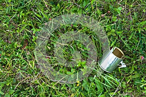 Empty tin can on the grass, human negligence