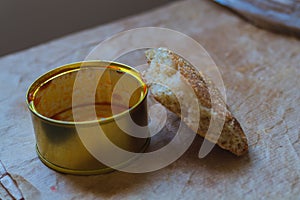 An empty tin can with the remains of tomato sauce with a slice of flat bread as a symbol of need and insufficient