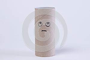 empty toilet paper roll with angry and sad face because the paper is gone