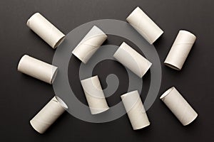 Empty toilet paper roll on colored background. Recyclable paper tube with metal plug end made of kraft paper or