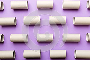 Empty toilet paper roll on colored background. Recyclable paper tube with metal plug end made of kraft paper or