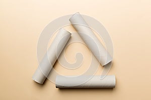 Empty toilet paper roll on colored background. Recyclable paper tube with metal plug end made of kraft paper or