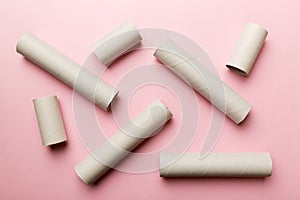 Empty toilet paper roll on colored background. Recyclable paper tube with metal plug end made of kraft paper or