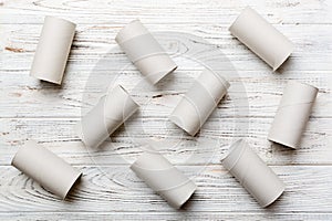 Empty toilet paper roll on colored background. Recyclable paper tube with metal plug end made of kraft paper or