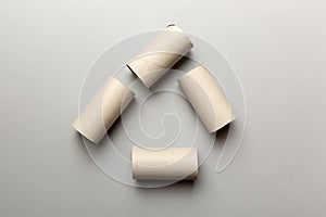 Empty toilet paper roll on colored background. Recyclable paper tube with metal plug end made of kraft paper or