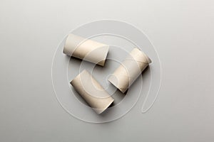 Empty toilet paper roll on colored background. Recyclable paper tube with metal plug end made of kraft paper or