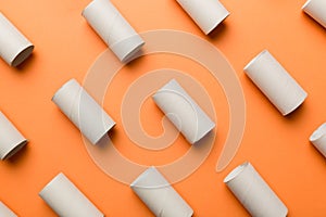 Empty toilet paper roll on colored background. Recyclable paper tube with metal plug end made of kraft paper or