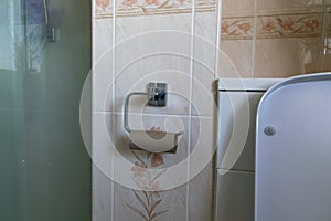 Empty Toilet roll cardboard tube on metal loo roll holder