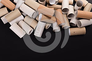 Empty Toilet Rolls Stack Up On a Black Background