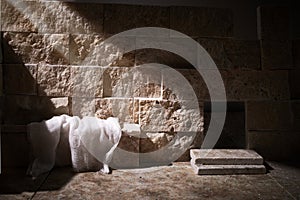 Empty tomb while light shines from the outside. Jesus Christ Resurrection. Christian Easter concept.