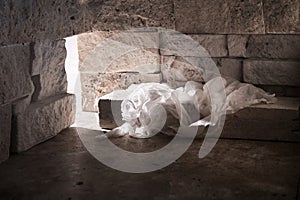 Empty tomb while light shines from the outside. Jesus Christ Resurrection. Christian Easter concept.