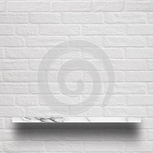 Empty top of white marble shelf with brick wall.